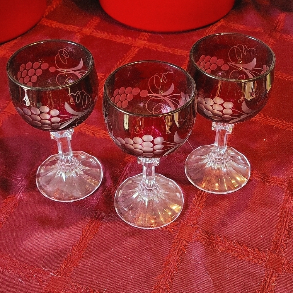 3 red crystal wine glasses.